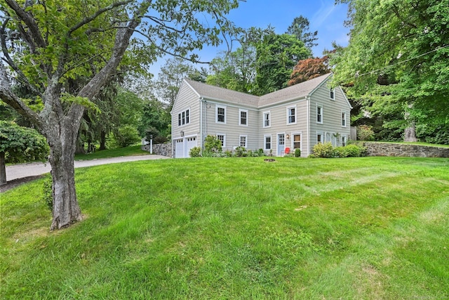 311 Wilton Rd E, Ridgefield, CT 06877 - colonial house featuring a garage, a front lawn, and driveway