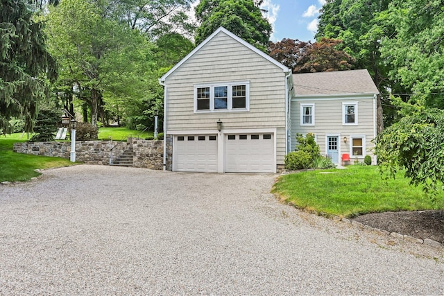 311 Wilton Rd E, Ridgefield, CT 06877 - view of front of home featuring driveway, an attached garage, roof with shingles, view of scattered trees, and a front lawn