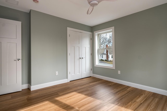 40 Allyn St, Groton, CT 06355 - unfurnished bedroom with wood finished floors, a closet, and ceiling fan