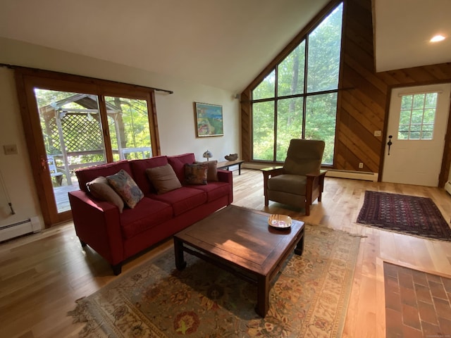 31 Weiss Rd, Haddam, CT 06438 - living area featuring a baseboard heating unit, lofted ceiling, light wood-type flooring, and wooden walls