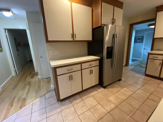 31 Weiss Rd, Haddam, CT 06438 - kitchen featuring stainless steel fridge, light countertops, white cabinetry, and light wood-style flooring
