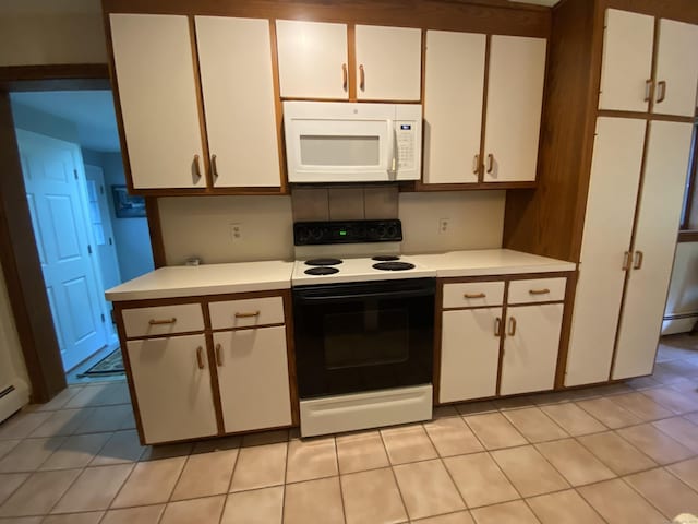 31 Weiss Rd, Haddam, CT 06438 - kitchen featuring white microwave, range with electric cooktop, light countertops, white cabinetry, and light tile patterned flooring