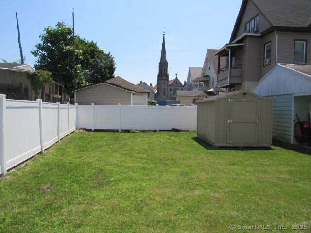 76 Porter St, Bridgeport, CT 06606 - fenced backyard featuring a shed and a residential view