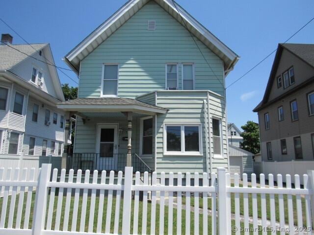 76 Porter St, Bridgeport, CT 06606 - view of front facade featuring a fenced front yard and covered porch