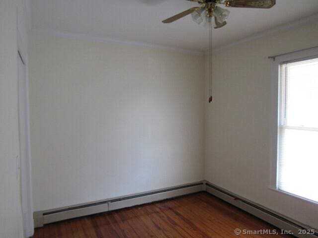 76 Porter St, Bridgeport, CT 06606 - spare room with ornamental molding, a ceiling fan, a baseboard heating unit, and wood finished floors