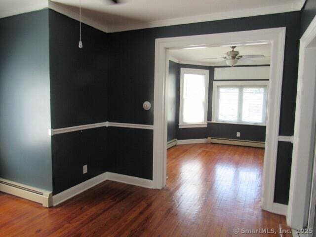 76 Porter St, Bridgeport, CT 06606 - unfurnished room with baseboard heating, wood finished floors, ornamental molding, and a ceiling fan