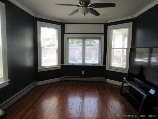 76 Porter St, Bridgeport, CT 06606 - empty room with a baseboard heating unit, baseboard heating, ornamental molding, dark wood-style flooring, and ceiling fan