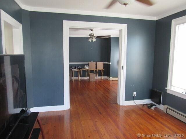 76 Porter St, Bridgeport, CT 06606 - dining area with a ceiling fan, a baseboard heating unit, ornamental molding, and wood finished floors