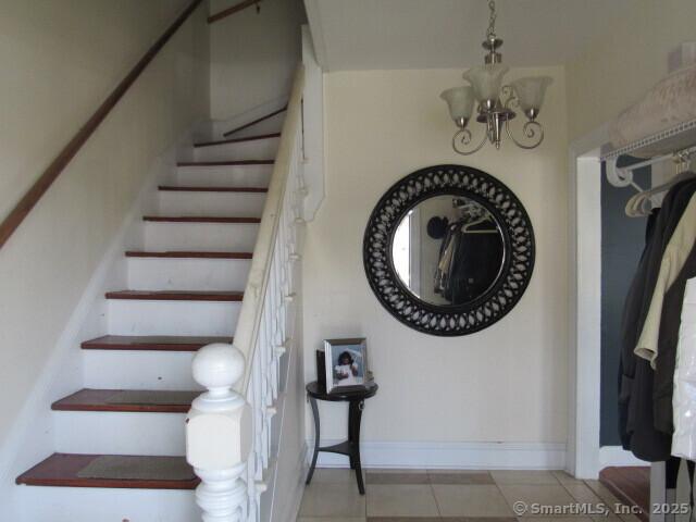 76 Porter St, Bridgeport, CT 06606 - stairway with a chandelier and tile patterned floors