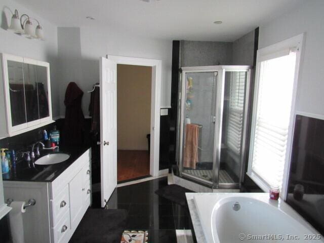 76 Porter St, Bridgeport, CT 06606 - bathroom featuring vanity, healthy amount of natural light, a garden tub, and a stall shower