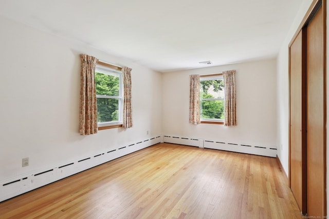 77 Old Middle Rd, Brookfield, CT 06804 - unfurnished bedroom featuring multiple windows, light wood-style flooring, and a baseboard heating unit
