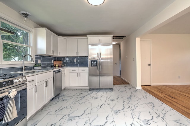 6 Overbrook Dr, East Hartford, CT 06118 - kitchen featuring stainless steel appliances, white cabinetry, backsplash, light countertops, and light marble finish floors