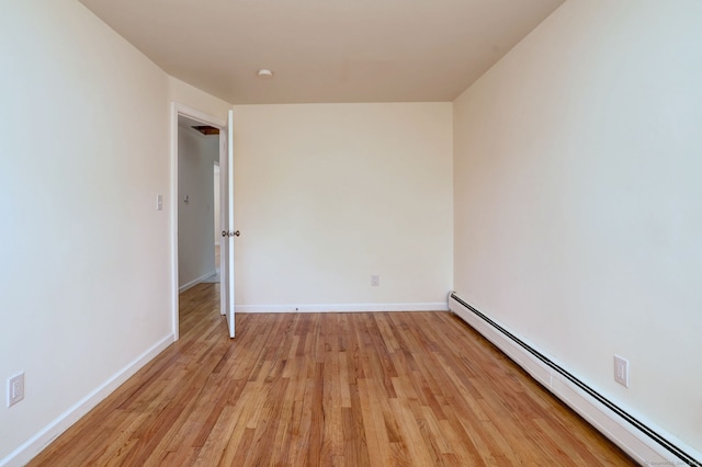 6 Overbrook Dr, East Hartford, CT 06118 - empty room with a baseboard heating unit and light wood finished floors