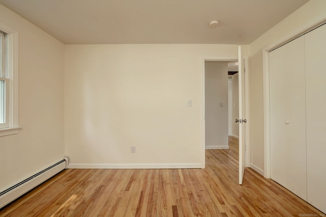 6 Overbrook Dr, East Hartford, CT 06118 - unfurnished bedroom with baseboard heating, light wood-type flooring, and a closet
