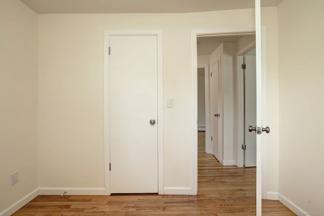 6 Overbrook Dr, East Hartford, CT 06118 - unfurnished bedroom with light wood-style flooring and a baseboard radiator