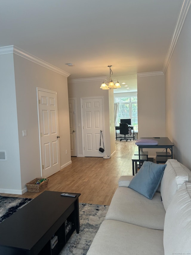 22 Wishing Well Ln Unit 22, New Milford, CT 06776 - living room with ornamental molding, a chandelier, and light wood-style flooring