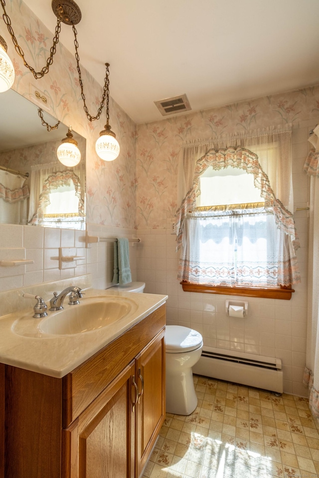 39 George Rd, Windsor Locks, CT 06096 - bathroom featuring a baseboard heating unit, tile walls, vanity, and wallpapered walls