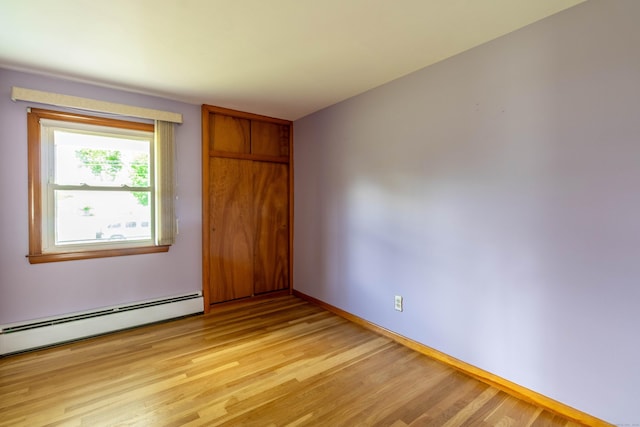 39 George Rd, Windsor Locks, CT 06096 - unfurnished bedroom featuring a baseboard radiator, light wood finished floors, and a closet