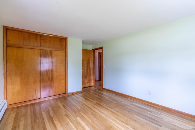 39 George Rd, Windsor Locks, CT 06096 - unfurnished bedroom featuring a closet, light wood-style flooring, and baseboard heating