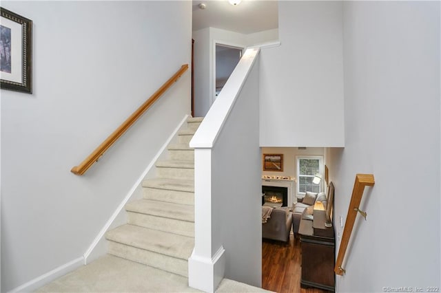1802 Larson Dr Unit 1802, Danbury, CT 06810 - stairway featuring a glass covered fireplace and wood finished floors