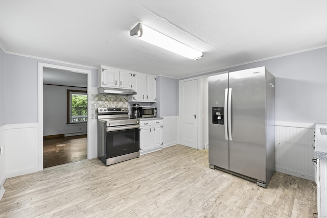 159 Bolton Rd, Vernon, CT 06066 - kitchen featuring stainless steel appliances, under cabinet range hood, white cabinets, light wood-style flooring, and a wainscoted wall