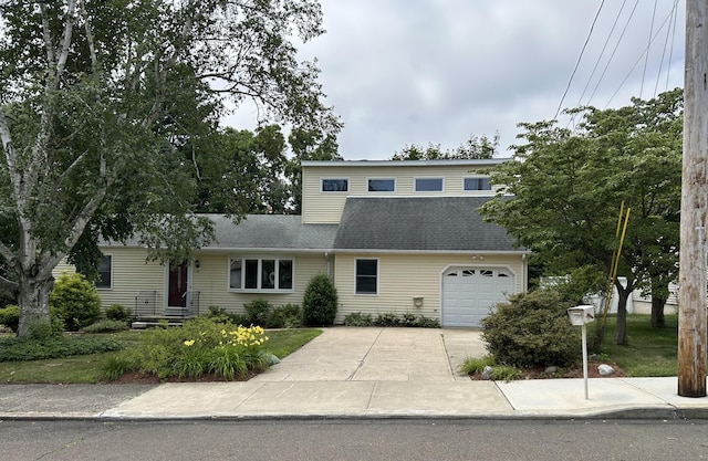 25 Andrus Dr, Milford, CT 06461 - view of front facade featuring concrete driveway, a garage, and roof with shingles