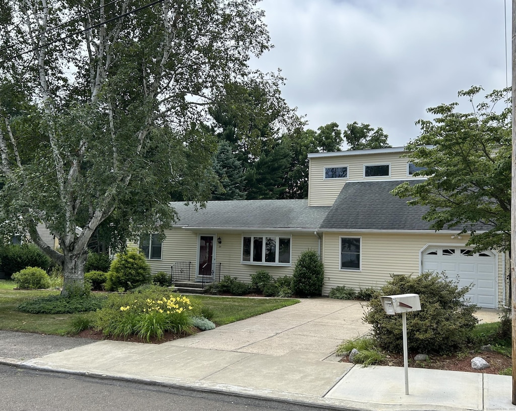 25 Andrus Dr, Milford, CT 06461 - view of front of property featuring driveway, a garage, and roof with shingles