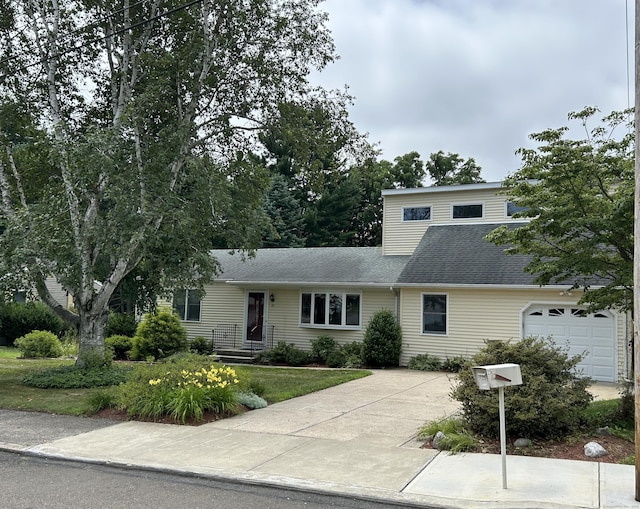 25 Andrus Dr, Milford, CT 06461 - view of front of property featuring driveway, a garage, and roof with shingles