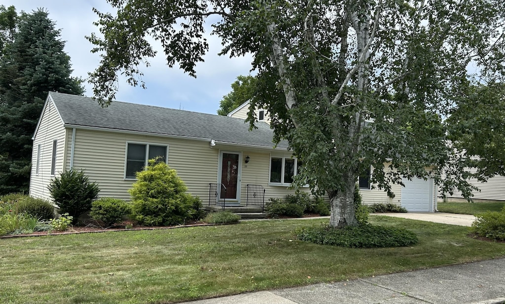 25 Andrus Dr, Milford, CT 06461 - view of front of home featuring a front lawn, a shingled roof, and driveway