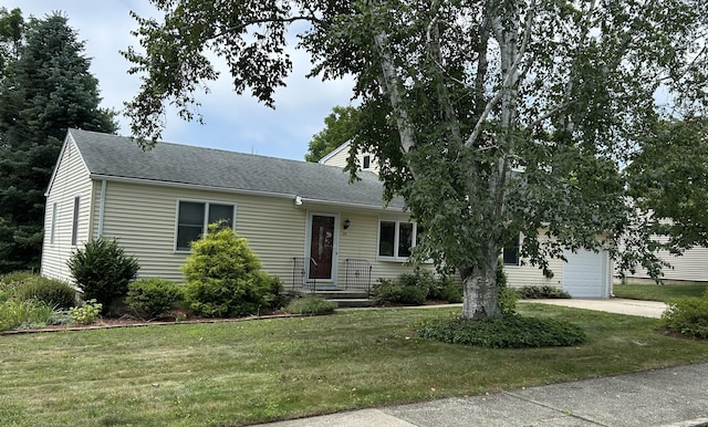25 Andrus Dr, Milford, CT 06461 - view of front of home featuring a front lawn, a shingled roof, and driveway