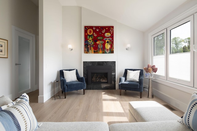 35 Emmons Ln, North Canaan, CT 06018 - living area with a fireplace, vaulted ceiling, and light wood-style flooring