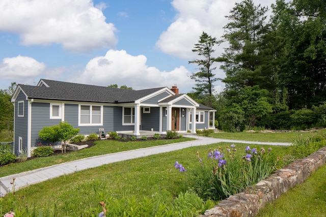 35 Emmons Ln, North Canaan, CT 06018 - view of front of house featuring a porch, a front yard, a chimney, and a shingled roof
