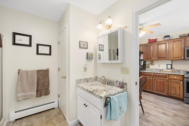 138 S Shore Rd, Killingly, CT 06241 - bathroom featuring baseboard heating, two vanities, and a ceiling fan