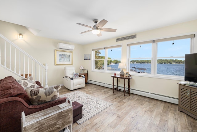 138 S Shore Rd, Killingly, CT 06241 - living room with an AC wall unit, baseboard heating, stairs, wood finished floors, and a ceiling fan