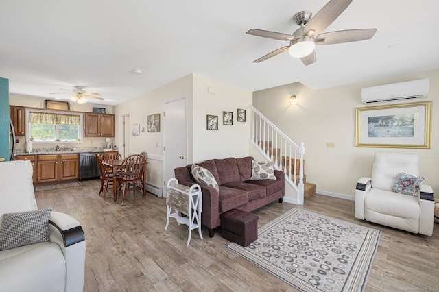 138 S Shore Rd, Killingly, CT 06241 - living room with an AC wall unit, a ceiling fan, stairs, light wood finished floors, and a baseboard heating unit