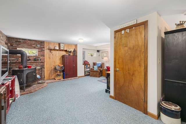 138 S Shore Rd, Killingly, CT 06241 - carpeted living room with a wood stove and brick wall