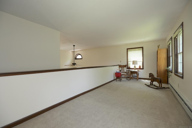 9 River Bend Ln, Windsor, CT 06095 - unfurnished room with a baseboard heating unit, light carpet, healthy amount of natural light, and a ceiling fan
