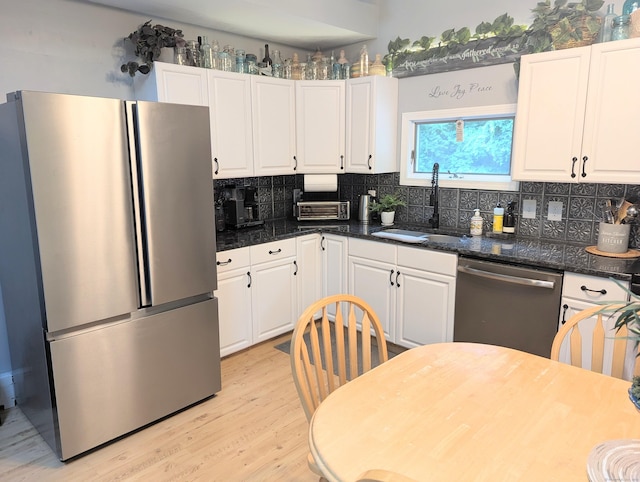 19 Wendell Rd, Ellington, CT 06029 - kitchen featuring appliances with stainless steel finishes, white cabinets, backsplash, and light wood-style flooring