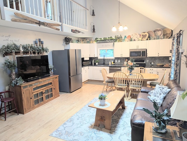 19 Wendell Rd, Ellington, CT 06029 - living room with high vaulted ceiling, light wood-type flooring, and a chandelier