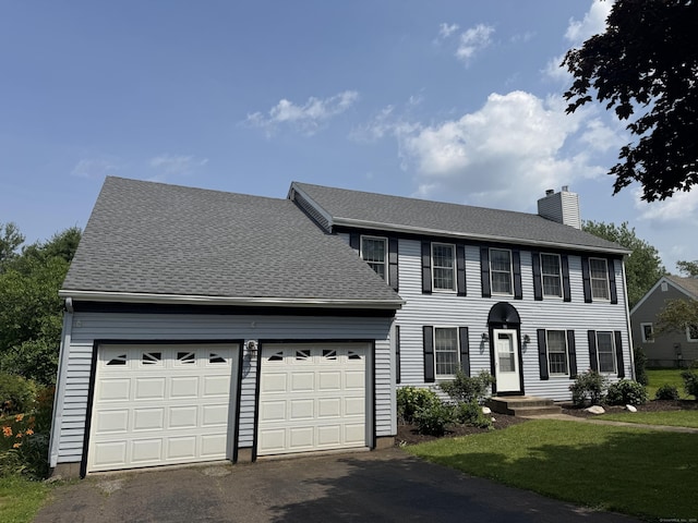 16 Snow Rdg S, Middletown, CT 06457 - colonial-style house with driveway, a garage, a chimney, and a front lawn