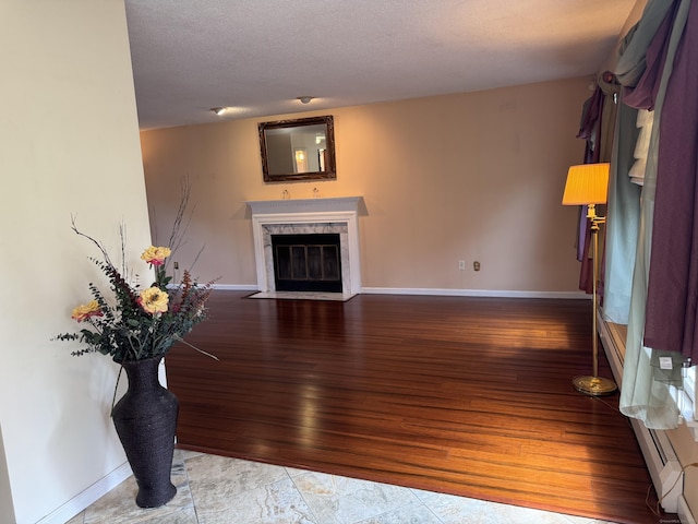16 Snow Rdg S, Middletown, CT 06457 - living area featuring a premium fireplace, wood finished floors, and a textured ceiling