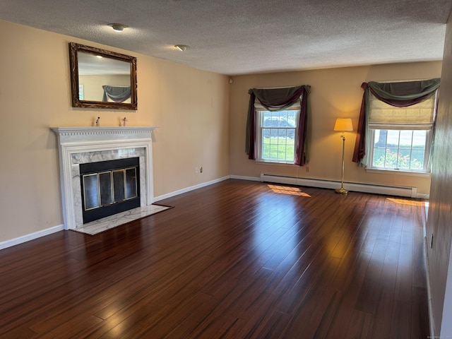 16 Snow Rdg S, Middletown, CT 06457 - unfurnished living room featuring baseboard heating, healthy amount of natural light, wood finished floors, a textured ceiling, and a high end fireplace