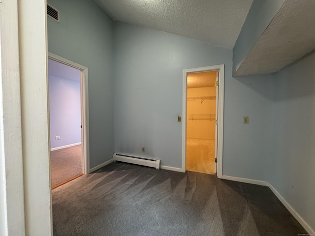 16 Snow Rdg S, Middletown, CT 06457 - empty room with a baseboard heating unit, lofted ceiling, dark colored carpet, and a textured ceiling