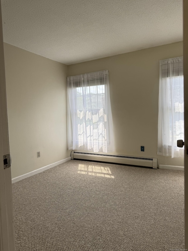 16 Snow Rdg S, Middletown, CT 06457 - carpeted spare room featuring a baseboard heating unit, healthy amount of natural light, and a textured ceiling