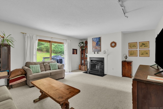148 Conestoga Way Unit 148, Glastonbury, CT 06033 - living room featuring track lighting, light carpet, a fireplace with flush hearth, and a textured ceiling