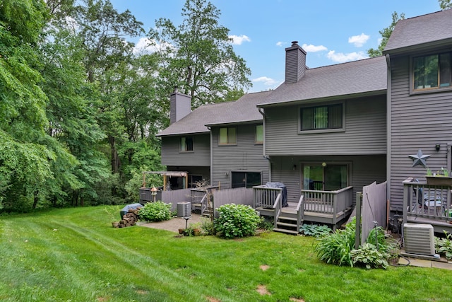 148 Conestoga Way Unit 148, Glastonbury, CT 06033 - back of property with a lawn, a chimney, a deck, and roof with shingles
