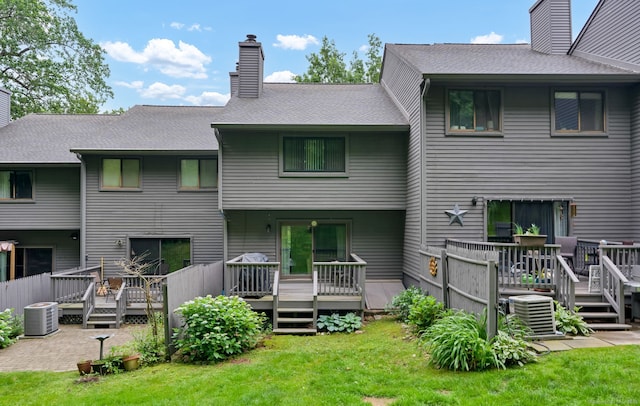 148 Conestoga Way Unit 148, Glastonbury, CT 06033 - rear view of property featuring a chimney, a lawn, and a deck