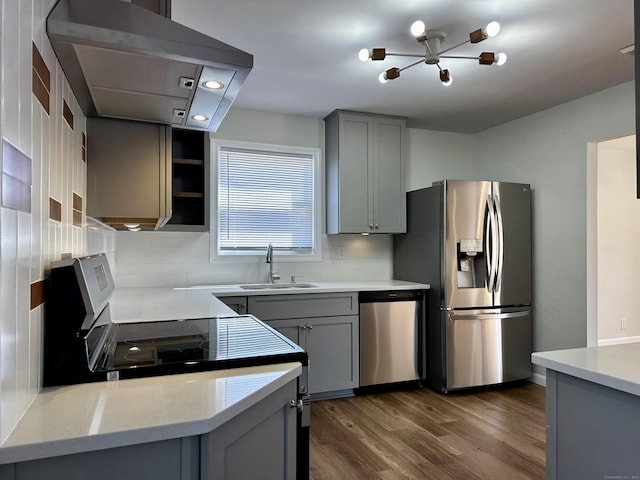 26 Riverdale Rd, Milford, CT 06460 - kitchen with stainless steel appliances, gray cabinets, dark wood-style flooring, exhaust hood, and light countertops
