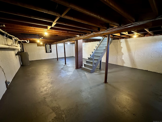 26 Riverdale Rd, Milford, CT 06460 - unfinished below grade area with stairway, electric panel, a textured wall, and water heater