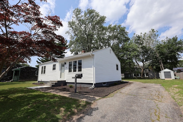 26 Riverdale Rd, Milford, CT 06460 - manufactured / mobile home with a storage unit, a front yard, a chimney, and cooling unit